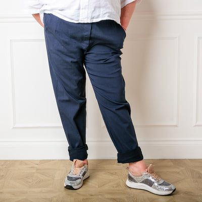 Plus size stretch trousers in navy blue with pockets on either side. The bottom hem can be rolled up to any length 