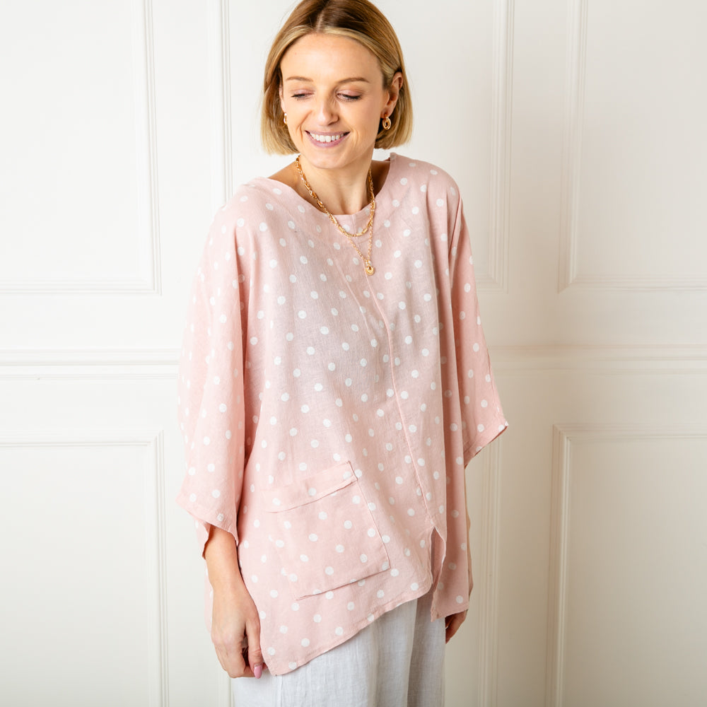 The pink Polka Dot Linen Blend Top with short sleeves and a round neckline 