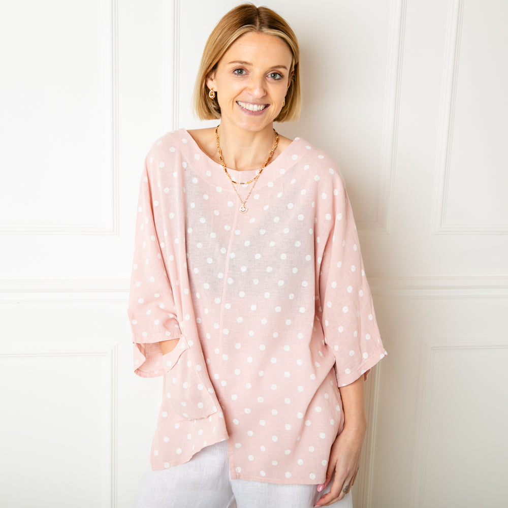 The pink Polka Dot Linen Blend Top with an asymmetrical hemline and a pocket on one side