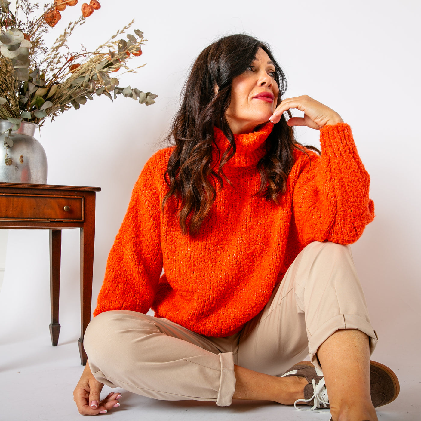 The orange Popcorn High Neck Jumper with long sleeves and ribbed cuffs