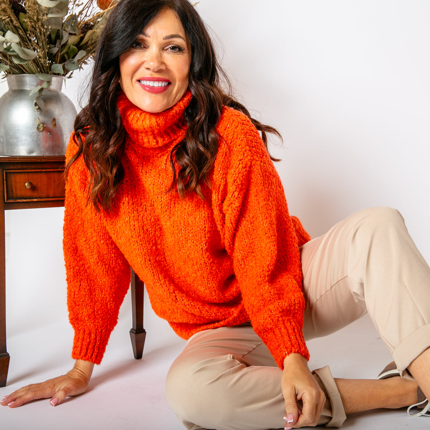 The orange Popcorn High Neck Jumper with a high neck that can be rolled to desired style