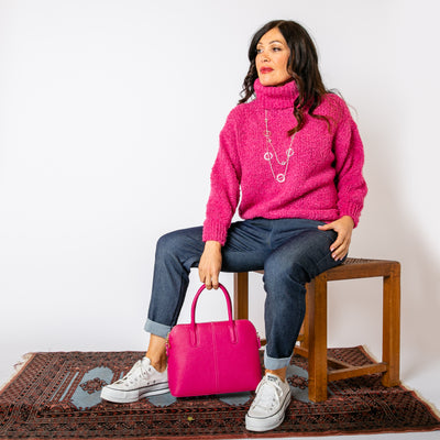 The raspberry pink Popcorn High Neck Jumper with a high neck that can be rolled to desired style