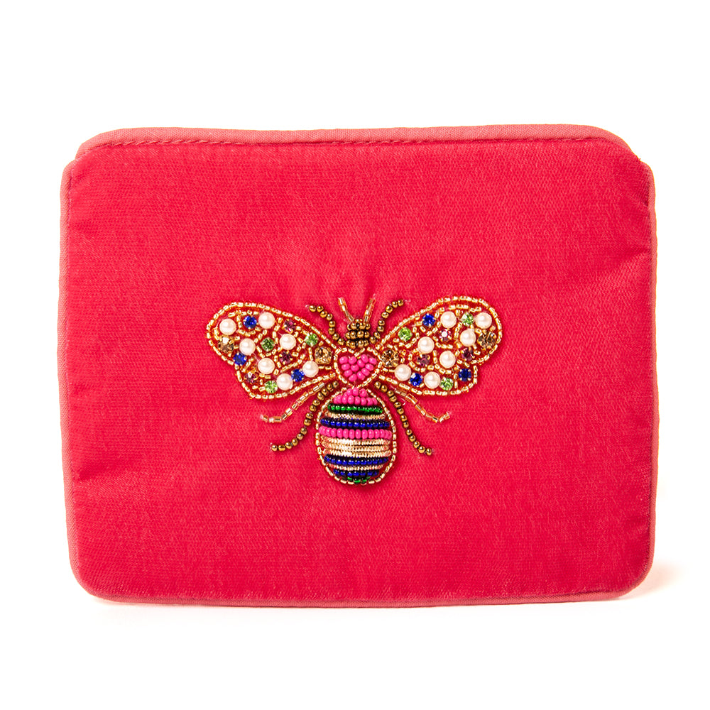 The Pouch in pink lovebug bee embroidery with blue piping trim around the edges