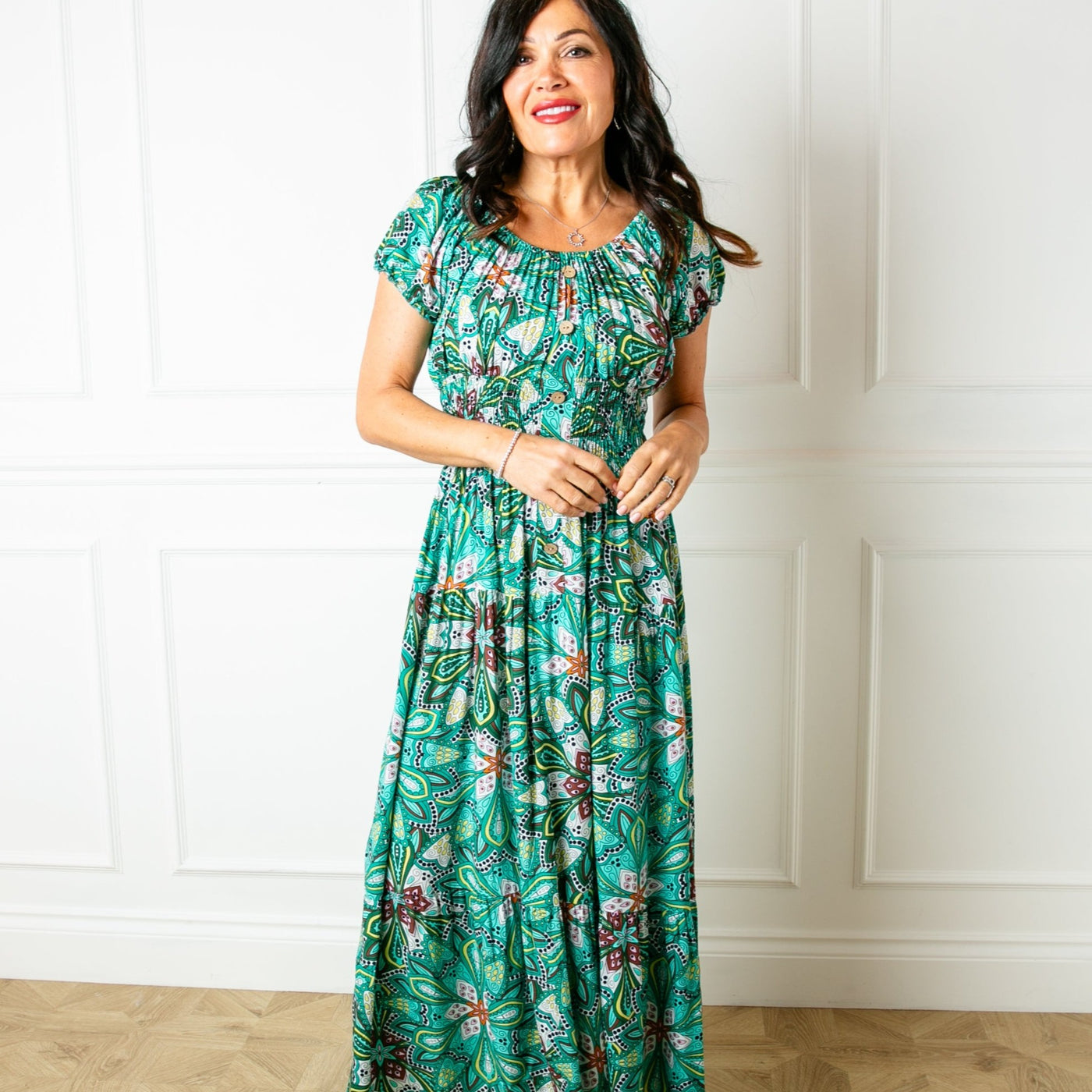 The green Printed Button Maxi Dress with short puffy elasticated sleeves that can be worn on or off the shoulder