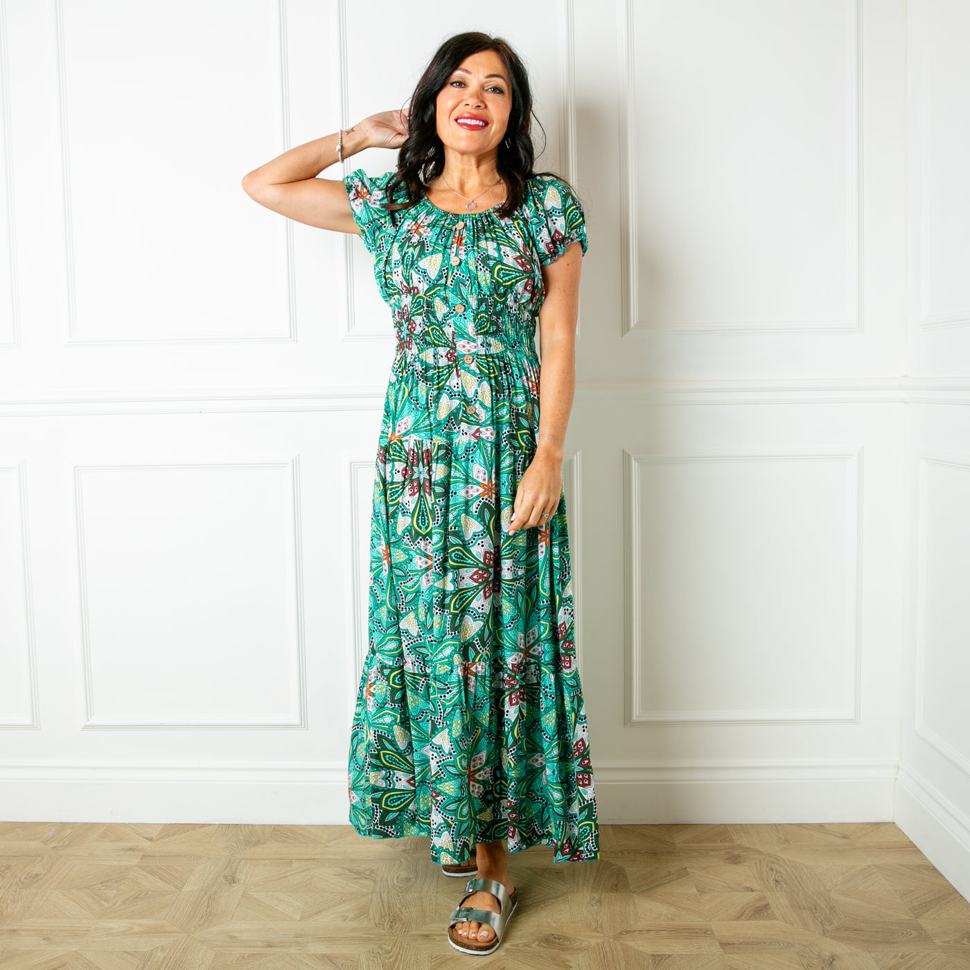 The green Printed Button Maxi Dress with a maxi tiered skirt in a fun summery pattern