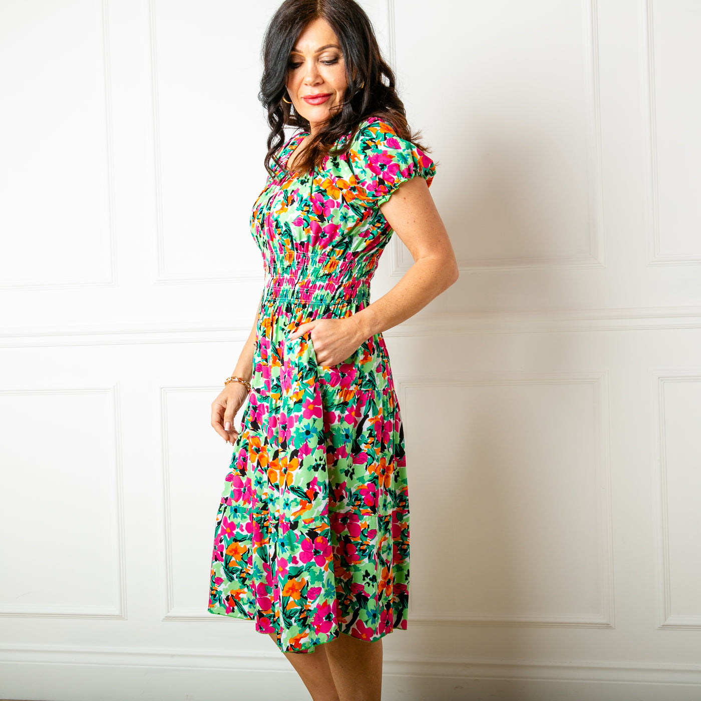 The floral green Printed Button Midi Dress with short puffy sleeves that are elasticated around the cuff