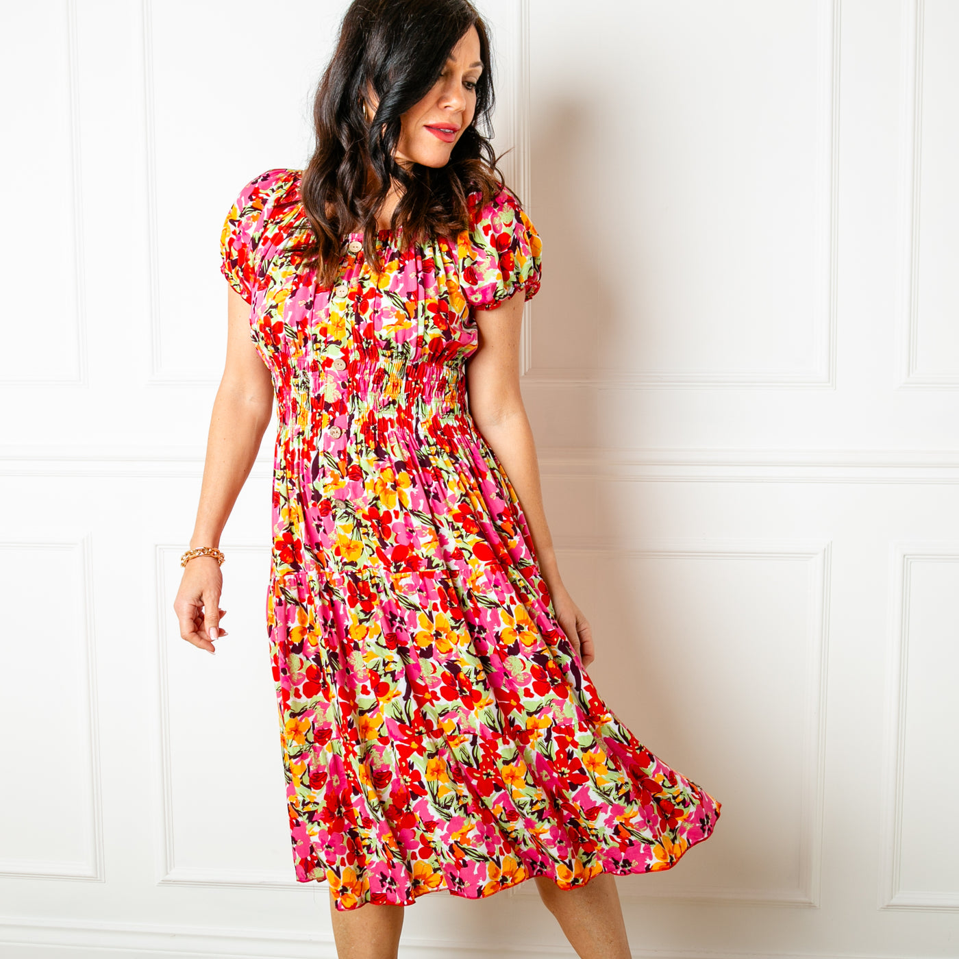 The floral red Printed Button Midi Dress with short puffy sleeves that are elasticated around the cuff