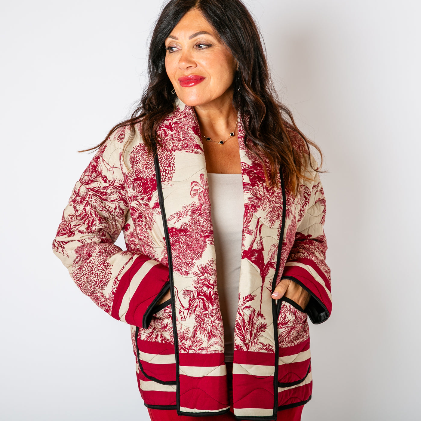 The Berry Red Rainforest Quilted Jacket with long sleeves and a folded over open front