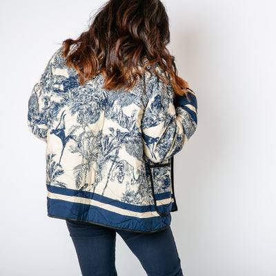 The navy blue Rainforest Quilted Jacket featuring a gorgeous intricate animal jungle print 