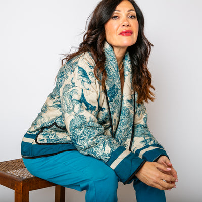 The teal blue Rainforest Quilted Jacket with long sleeves and a folded over open front