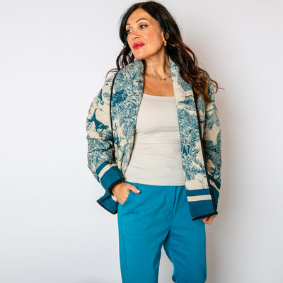 The Teal Blue Rainforest Quilted Jacket with pockets on either side of the hips