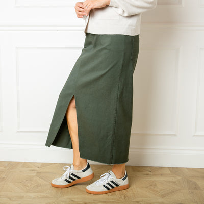 The khaki green Raw Hem Midi Skirt made from a super stretchy fabric made of viscose, nylon and spandex