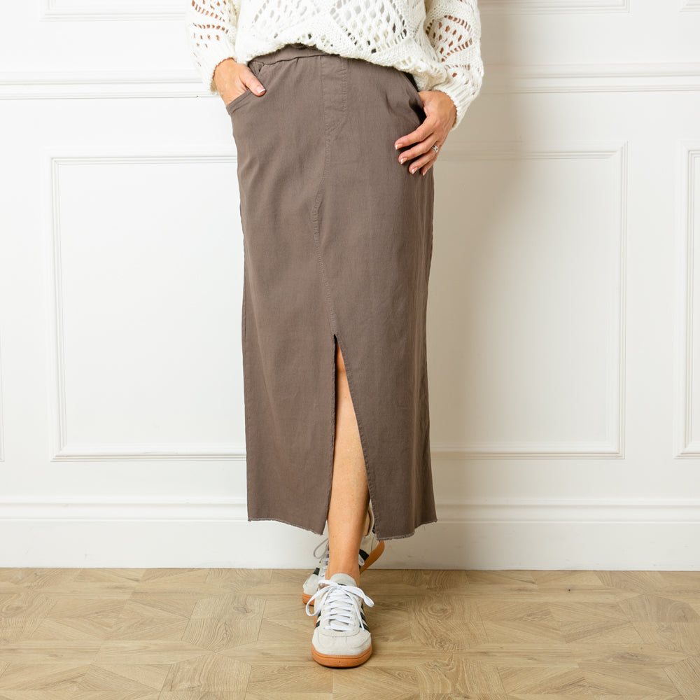 The taupe brown Raw Hem Midi Skirt made from a super stretchy fabric made of viscose, nylon and spandex