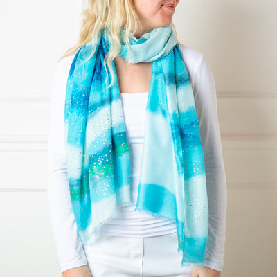 The blue Coral reef Scarf featuring specks spots of gold foil for a bit of extra sparkle