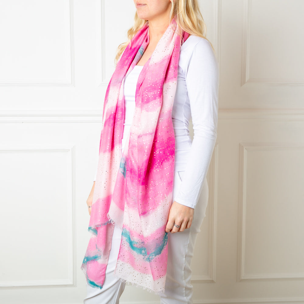 The pink Reef Scarf featuring a beautiful gentle watercolour effect striped pattern 
