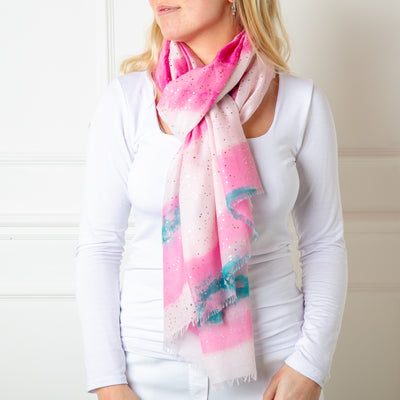 The fuchsia pink Coral reef Scarf featuring specks spots of gold foil for a bit of extra sparkle