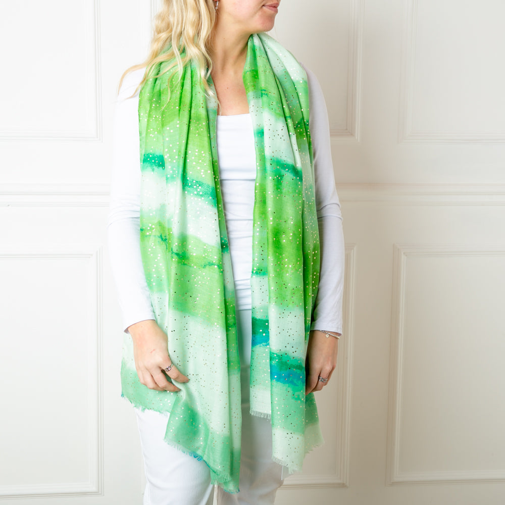 The green Coral reef Scarf featuring specks spots of gold foil for a bit of extra sparkle
