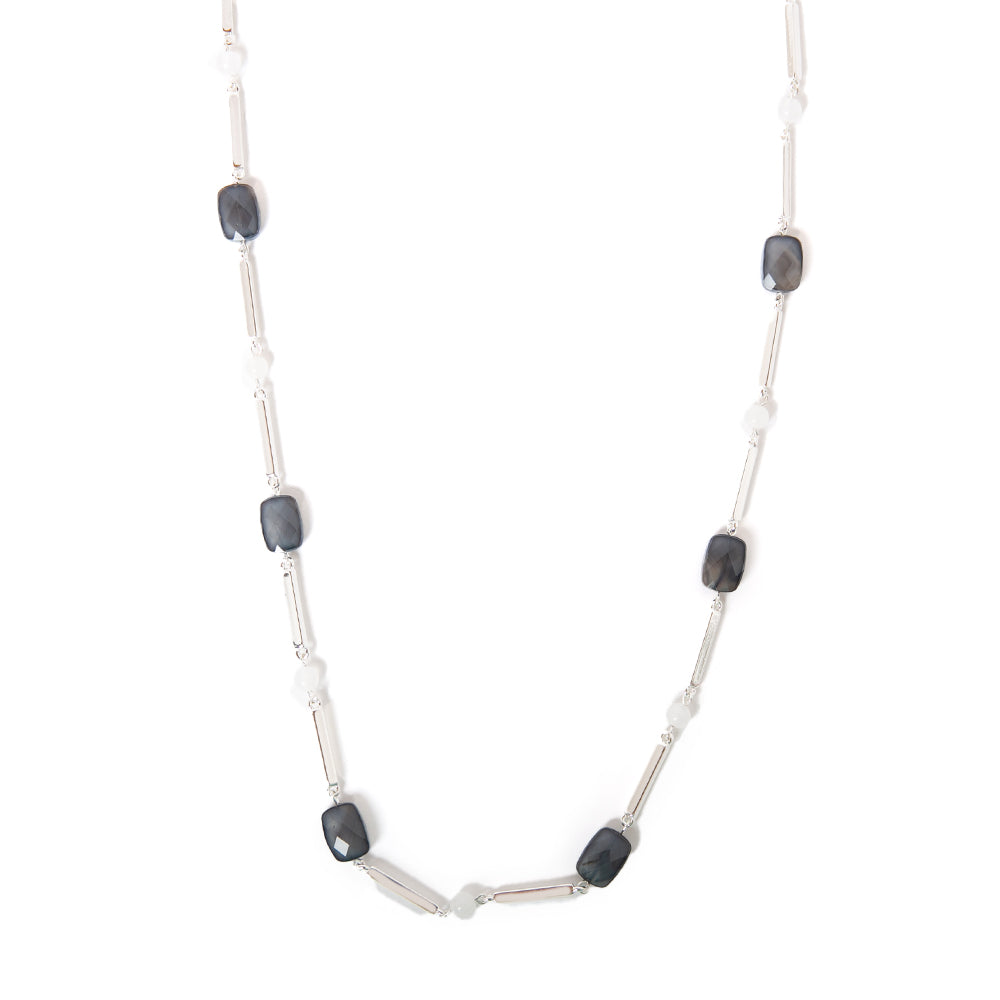 The Rhea necklace in silver with blue and white beads dotted along the chain