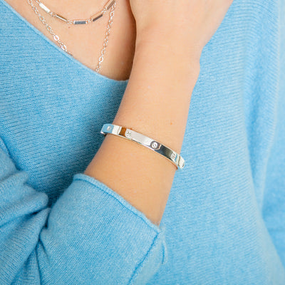 The silver Roxanne Cuff Bracelet with a hinge to open and a magnet clasp fastening for easy wear