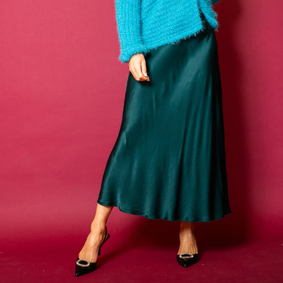 The midnight green Satin Slip Skirt in a midi length, perfect for autumn and winter