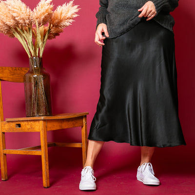 The black Satin Slip Skirt with an elasticated waistband for added comfort