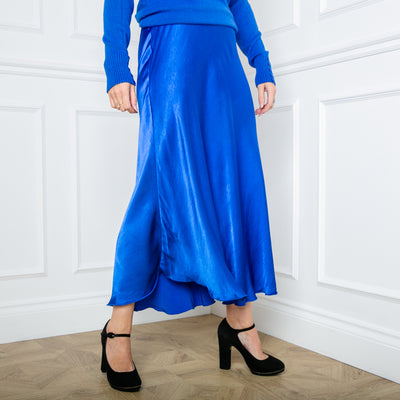 The Satin Slip Skirt in royal blue in a midi length with an elasticated waistband.