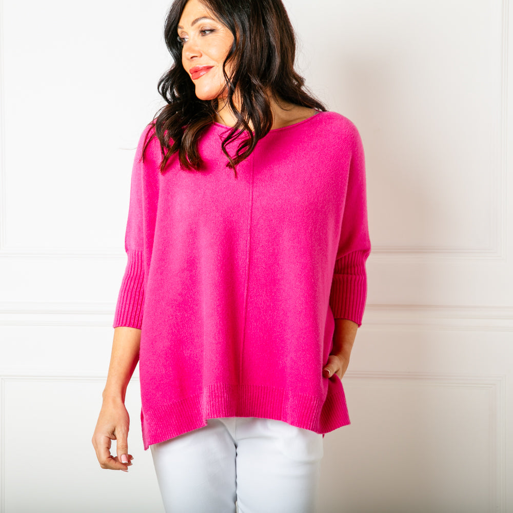 The Seam Front Jumper in fuchsia pink with 3/4 length sleeves that have ribbed detailing around the cuffs