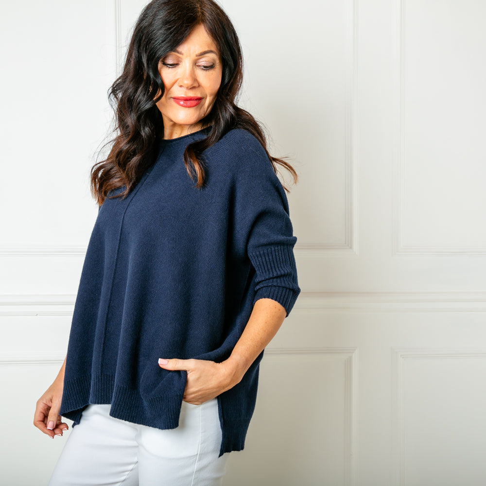 The Seam Front Jumper in navy blue with a round neckline and and a relaxed longer length