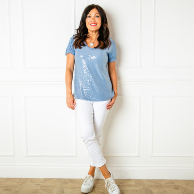 The denim blue Sequin T-shirt with a silky raw edge hem on the sleeve cuffs and around the neckline