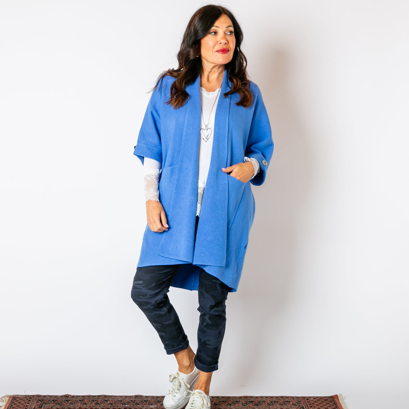 The cornflower blue Shawl Button Cardigan with pockets on either side of the hip