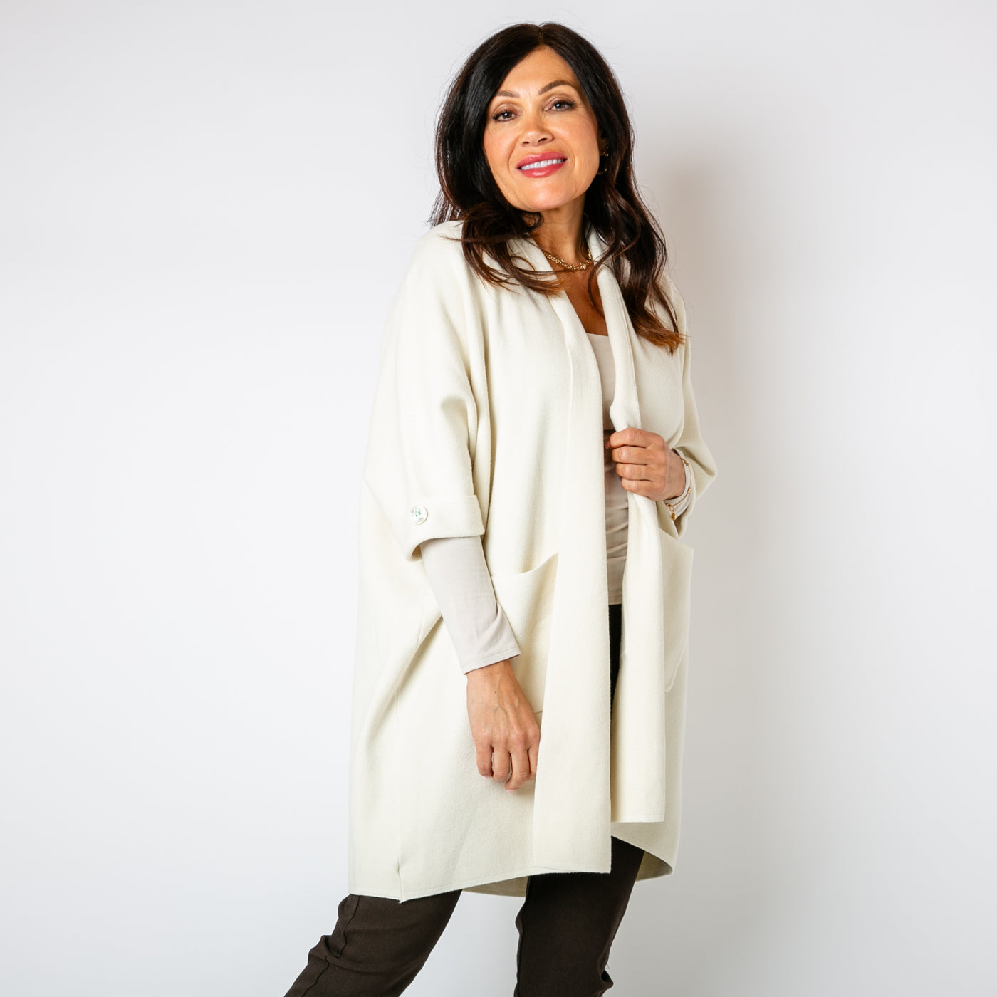 The cream Shawl Button Cardigan with pockets on either side of the hip