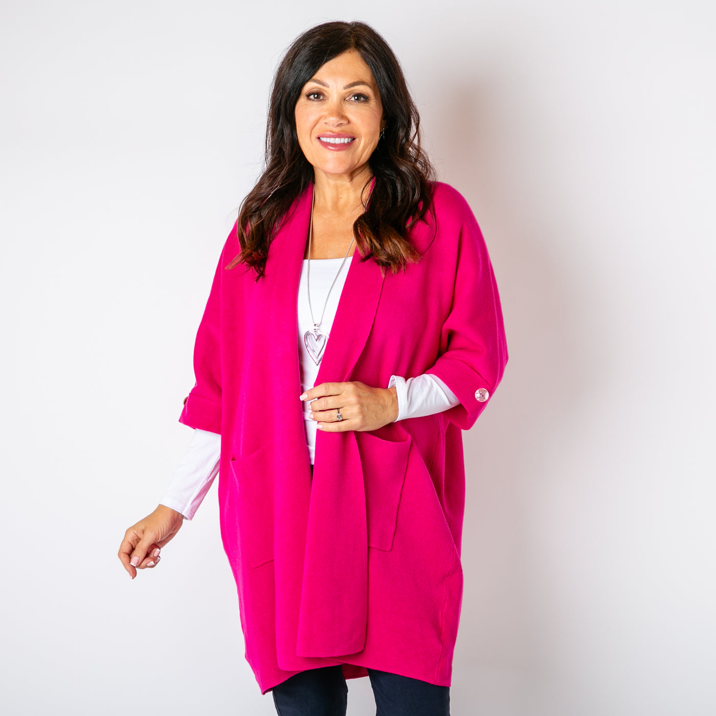 The fuchsia pink Shawl Button Cardigan with 3/4 length sleeves featuring a button detail 