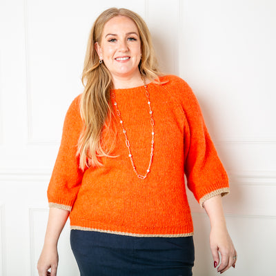 The Shimmer Trim Jumper in orange with gold glitter sparkly ribbed trims around the sleeve cuffs and bottom hem