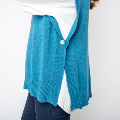 The teal blue Side Button Knitted Vest, open on either side with a button to fasten