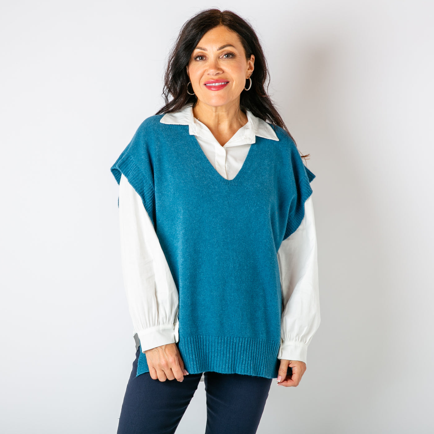 The teal blue Side Button Knitted Vest with a v neckline, great for layering with a shirt 