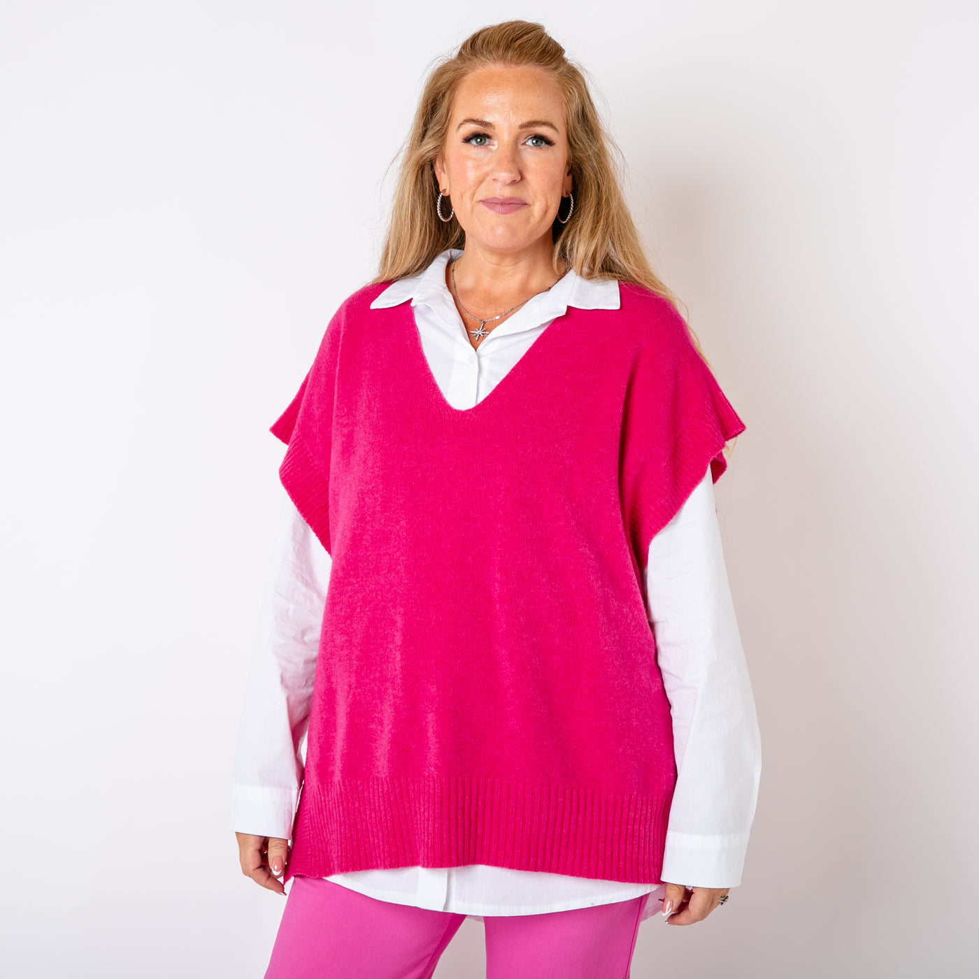 The fuchsia pink Side Button Knitted Vest with a v neckline, great for layering with a shirt 