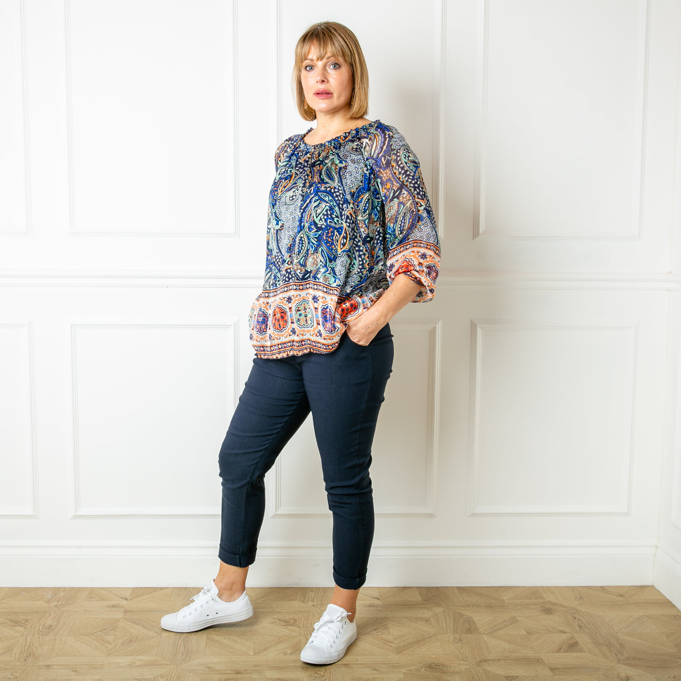 The navy blue Silk Blend Paisley Top with a round neckline with elastic and gathering around the neckline