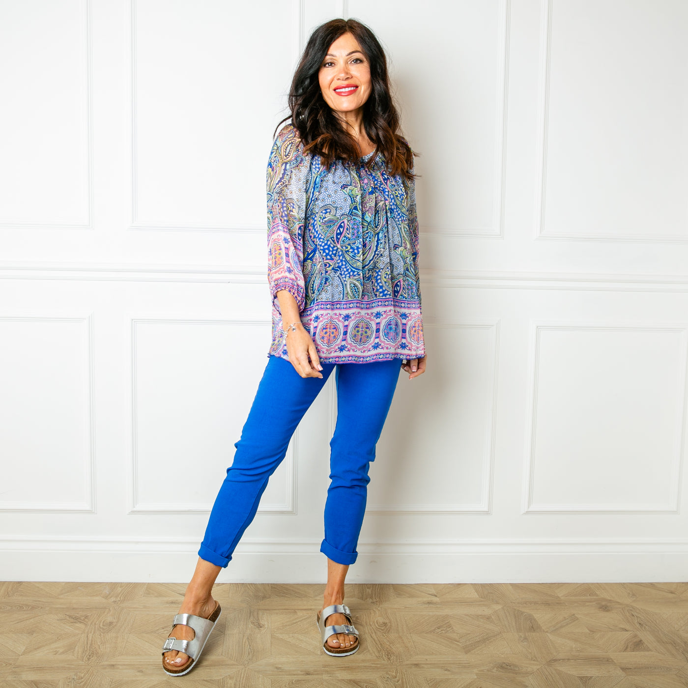 The royal blue Silk Blend Paisley Top with a round neckline with elastic and gathering around the neckline