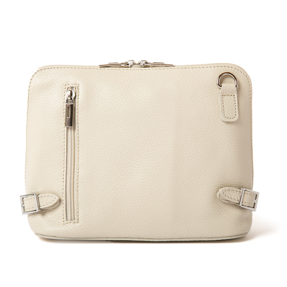 Cream Italian leather Sloane Handbag, with a adjustable leather strap, three side zip, buckle detail and the outside pocket. Shown from the front.