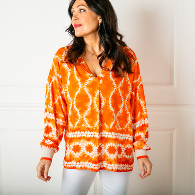 The orange Tie Dye Jersey Cuff Top with long sleeves that have a stretchy contrasting cuff
