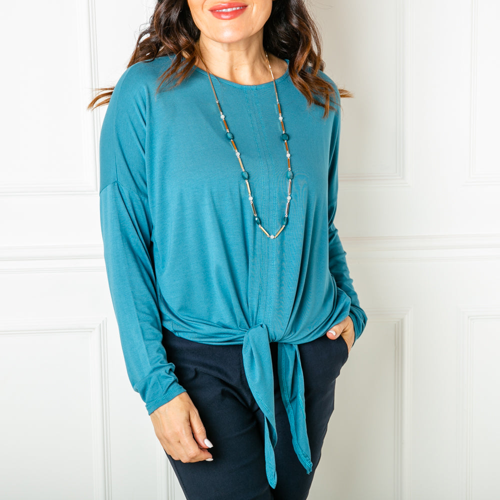 The Tie front top in teal blue with a ruched tie front detail on the bottom hem that can be adjusted to suit