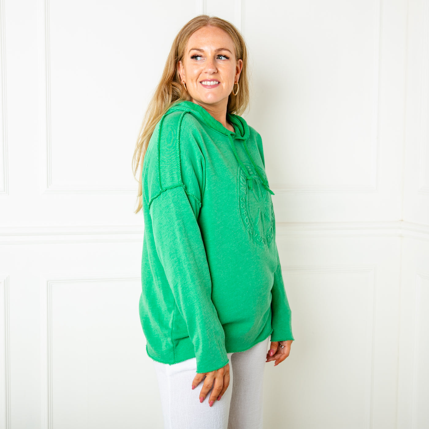 The green Towelling Hoodie with long sleeves and a logo design on the front