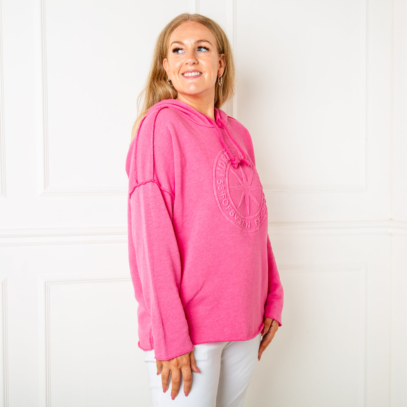 The pink Towelling Hoodie with long sleeves and a logo design on the front