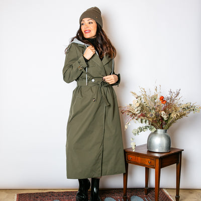 The khaki green Trench Coat With Hood that has long sleeves that have buckles on the cuffs.