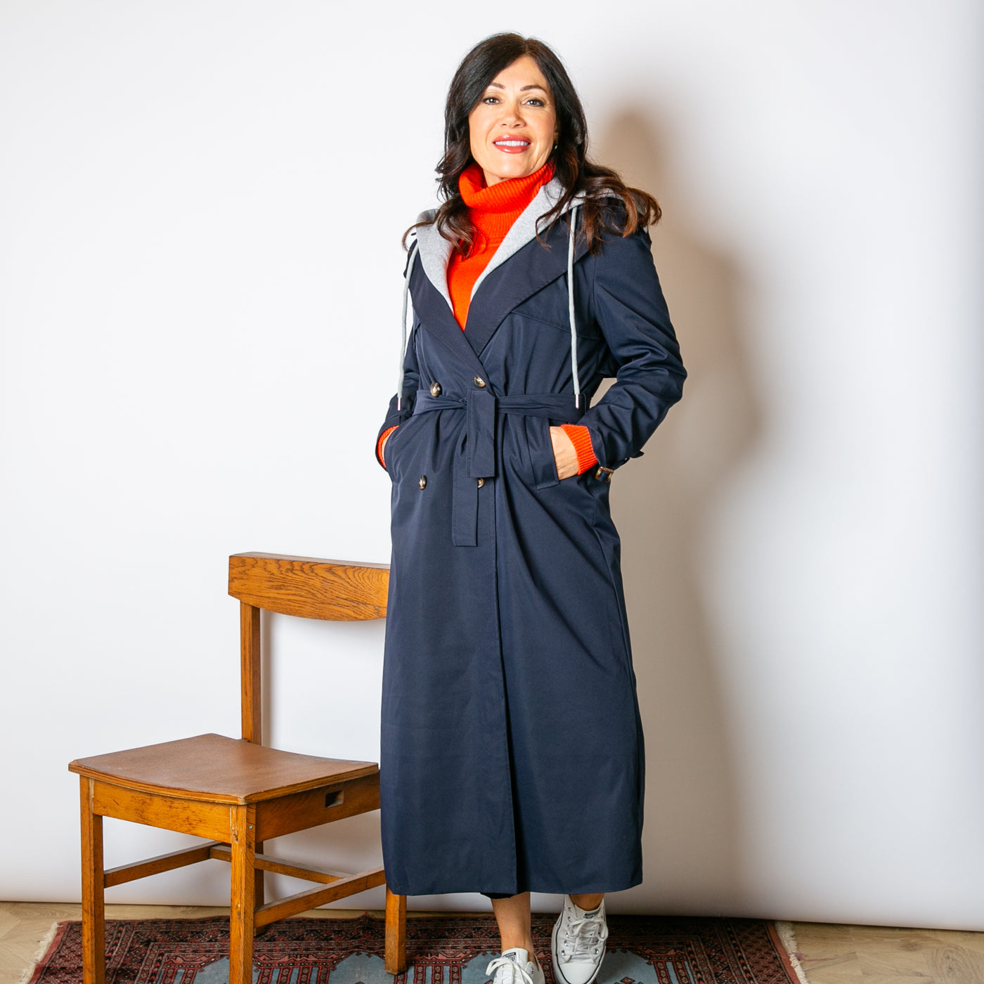 The navy blue Trench Coat With Hood with a longline silhouette and a contrasting grey hood