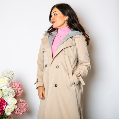 The stone cream Trench Coat With Hood that has a belt to tie around the waist and button fastening