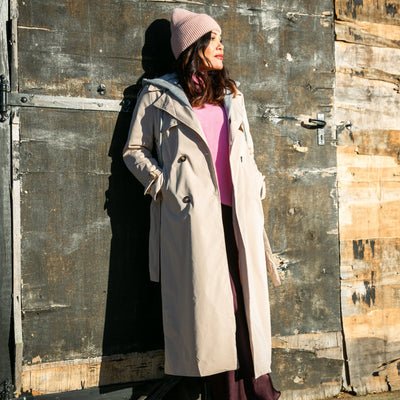 The stone cream Trench Coat With Hood with pockets on either side of the hip