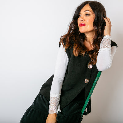 The Two Button Sleeveless Cardigan in Black with chunky, statement buttons down the front