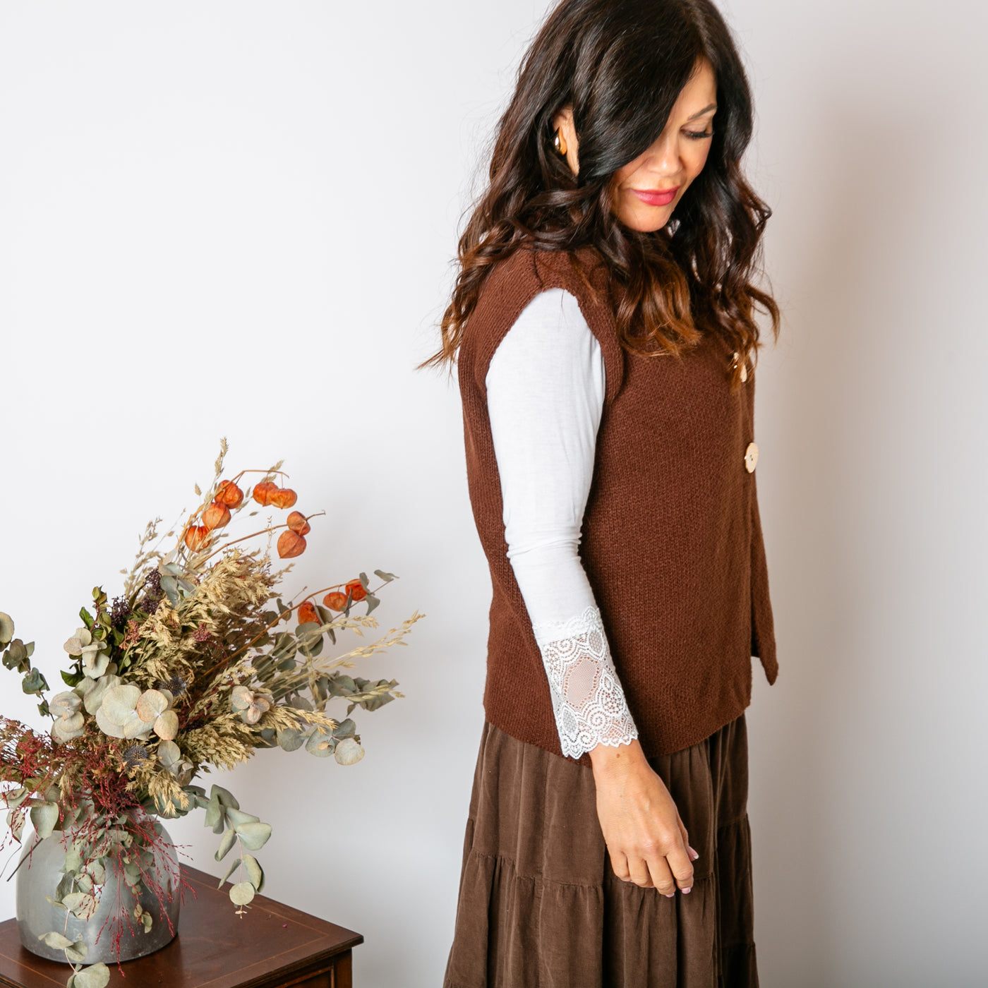 The Two Button Sleeveless Cardigan in Chocolate brown with chunky, statement buttons down the front