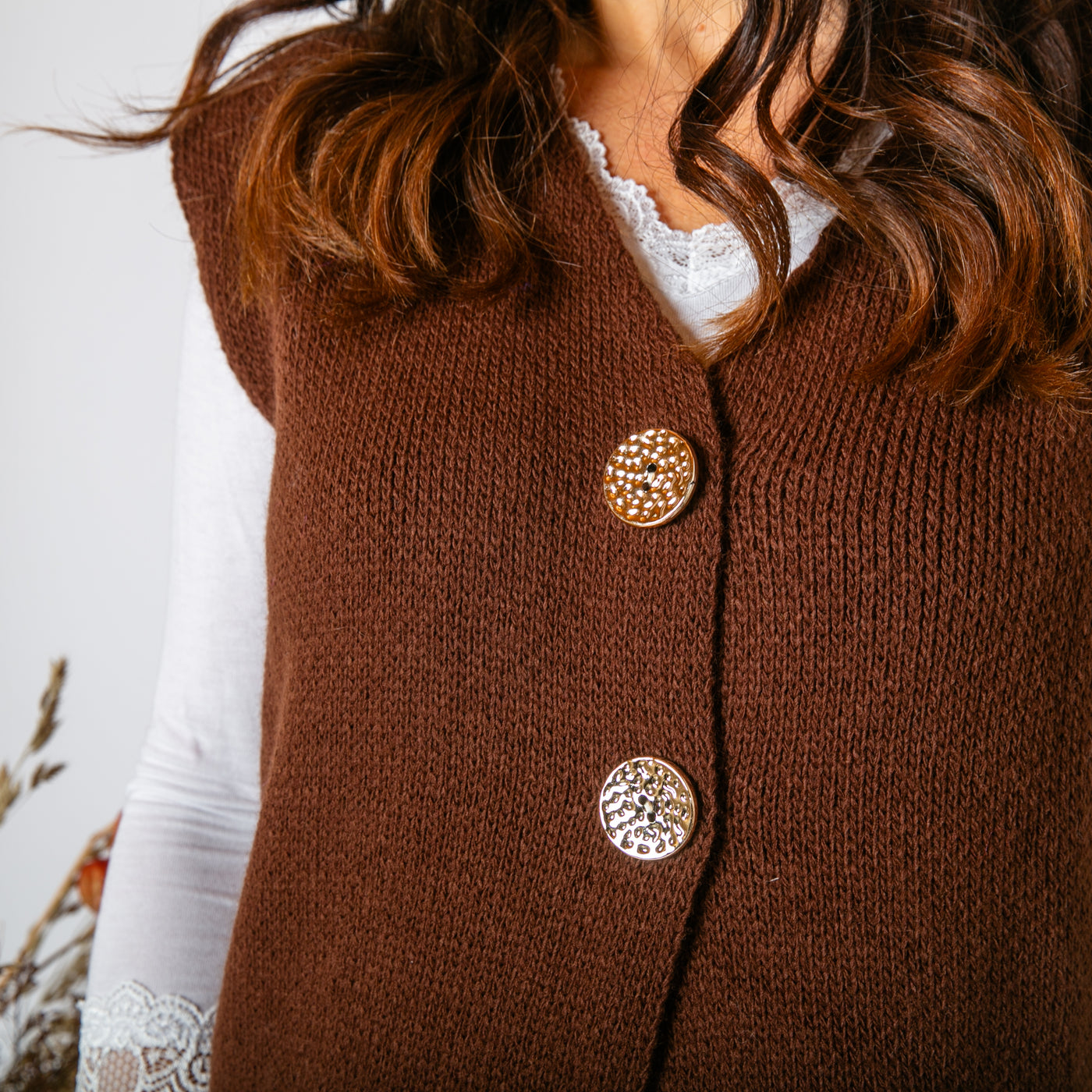 The Two Button Sleeveless Cardigan in chocolate brown made from 100% acrylic 